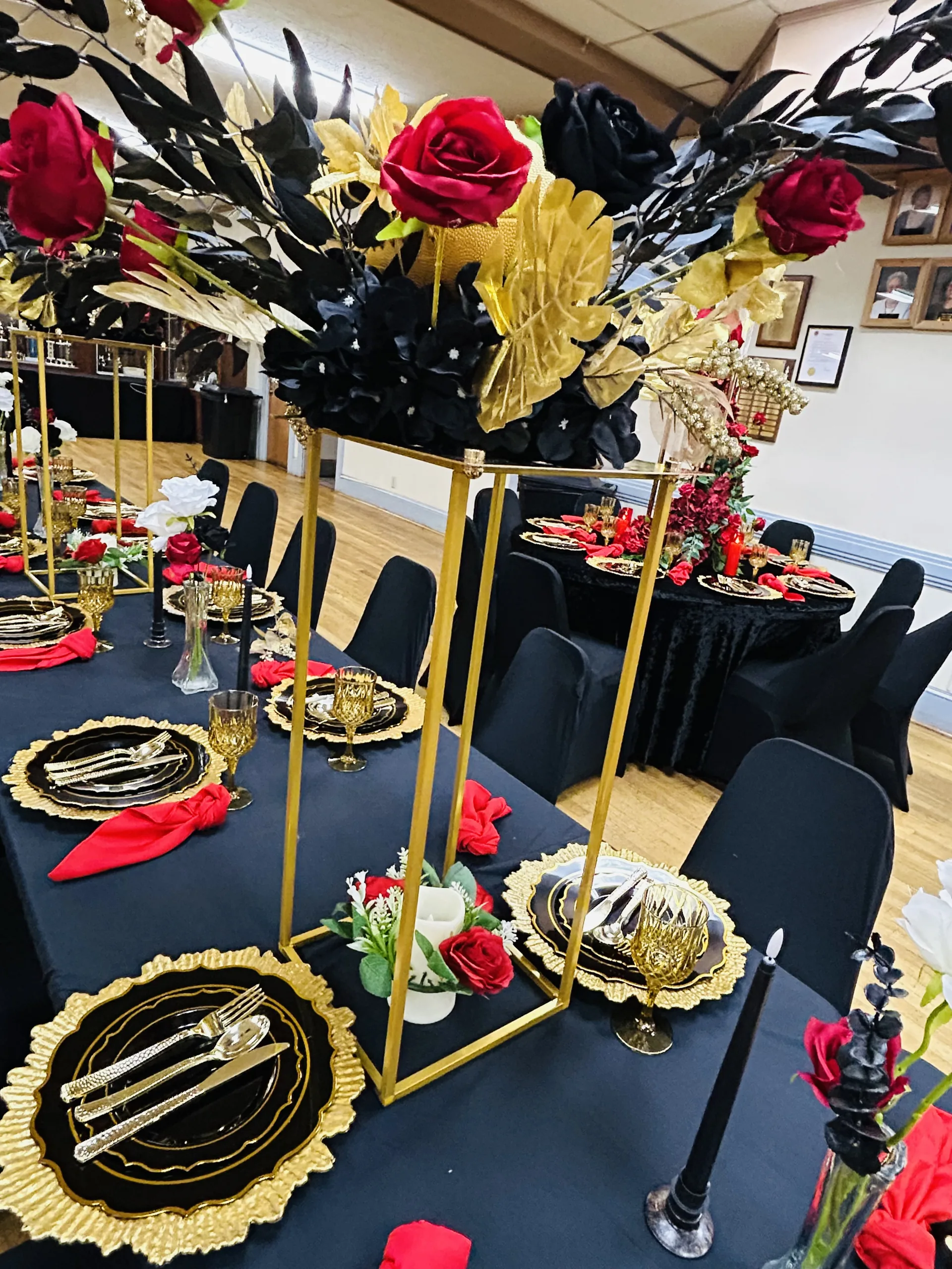 Black red and gold table decor with floral centerpiece