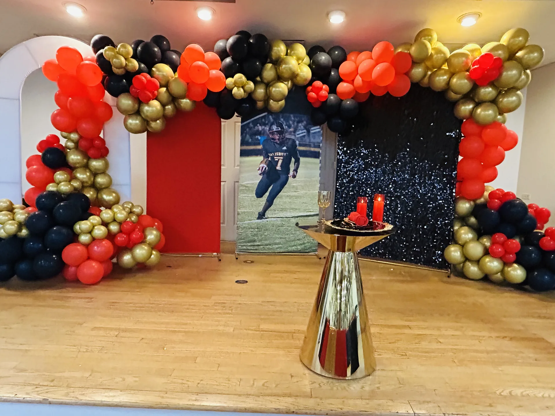 Black red and gold graduation balloon backdrop with custom styling