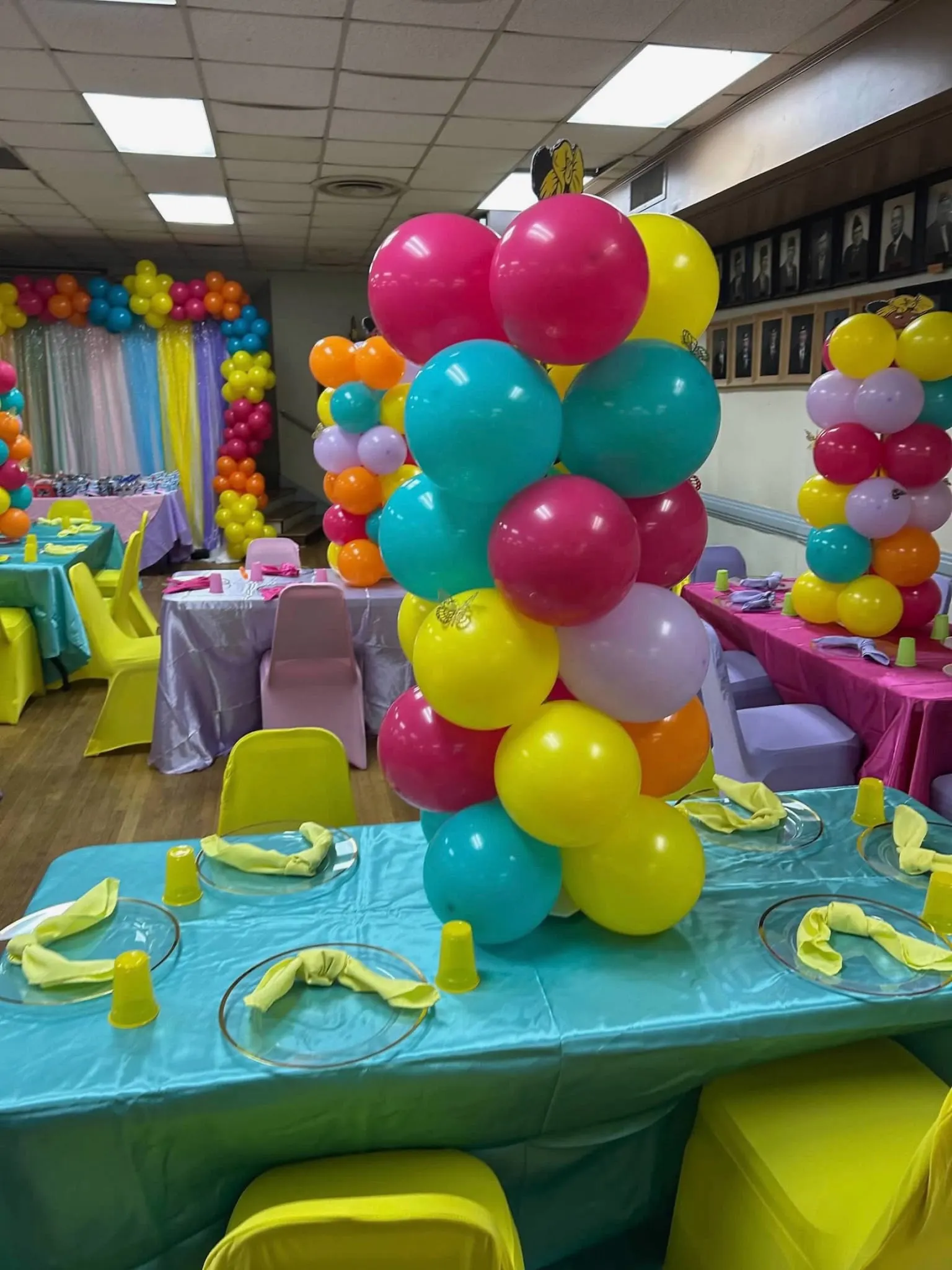 Colorful balloon centerpiece above a turquoise children's birthday tablescape