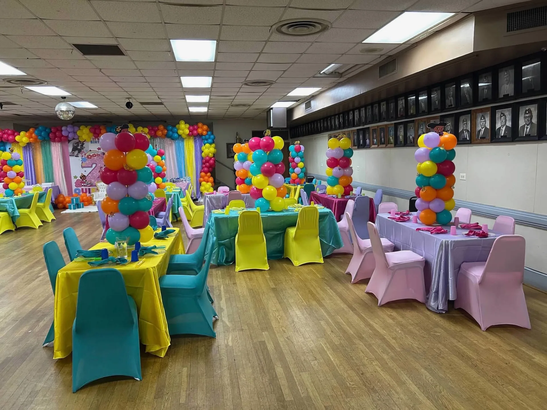 Wide room view with colorful children's tables and custom balloon centerpieces