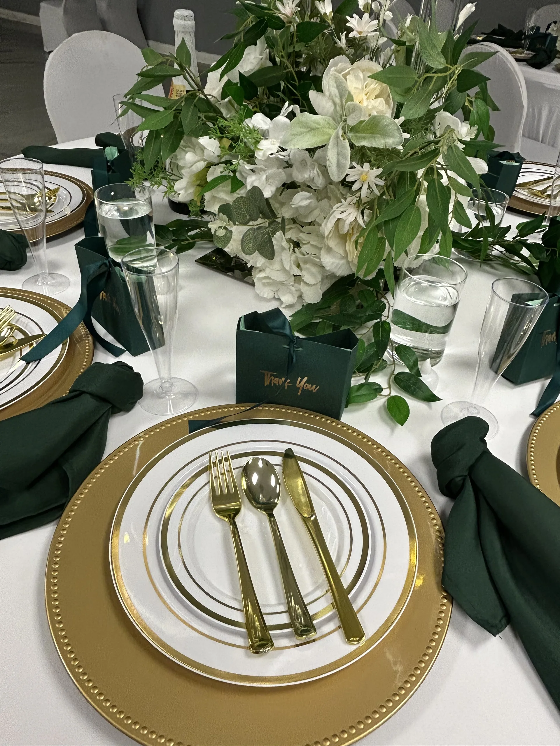 Close-up of gold charger plate and emerald napkin