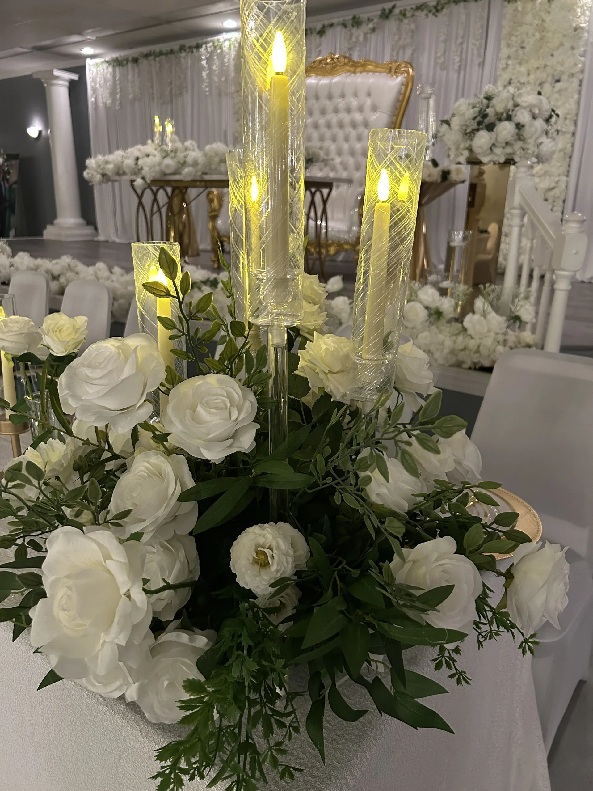 White floral reception centerpiece with candlelight and luxury seating