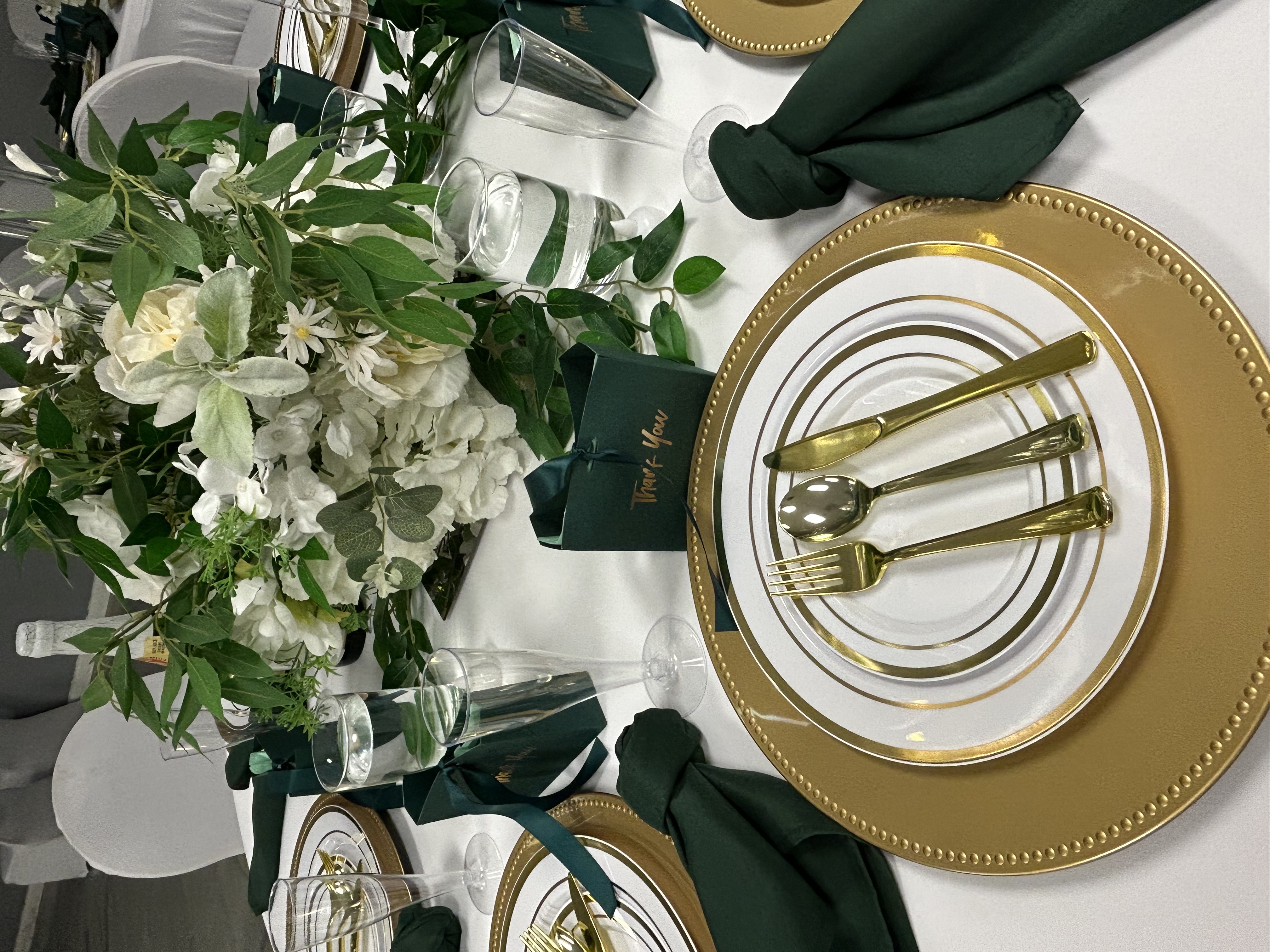 Close-up of gold charger plate and emerald napkin
