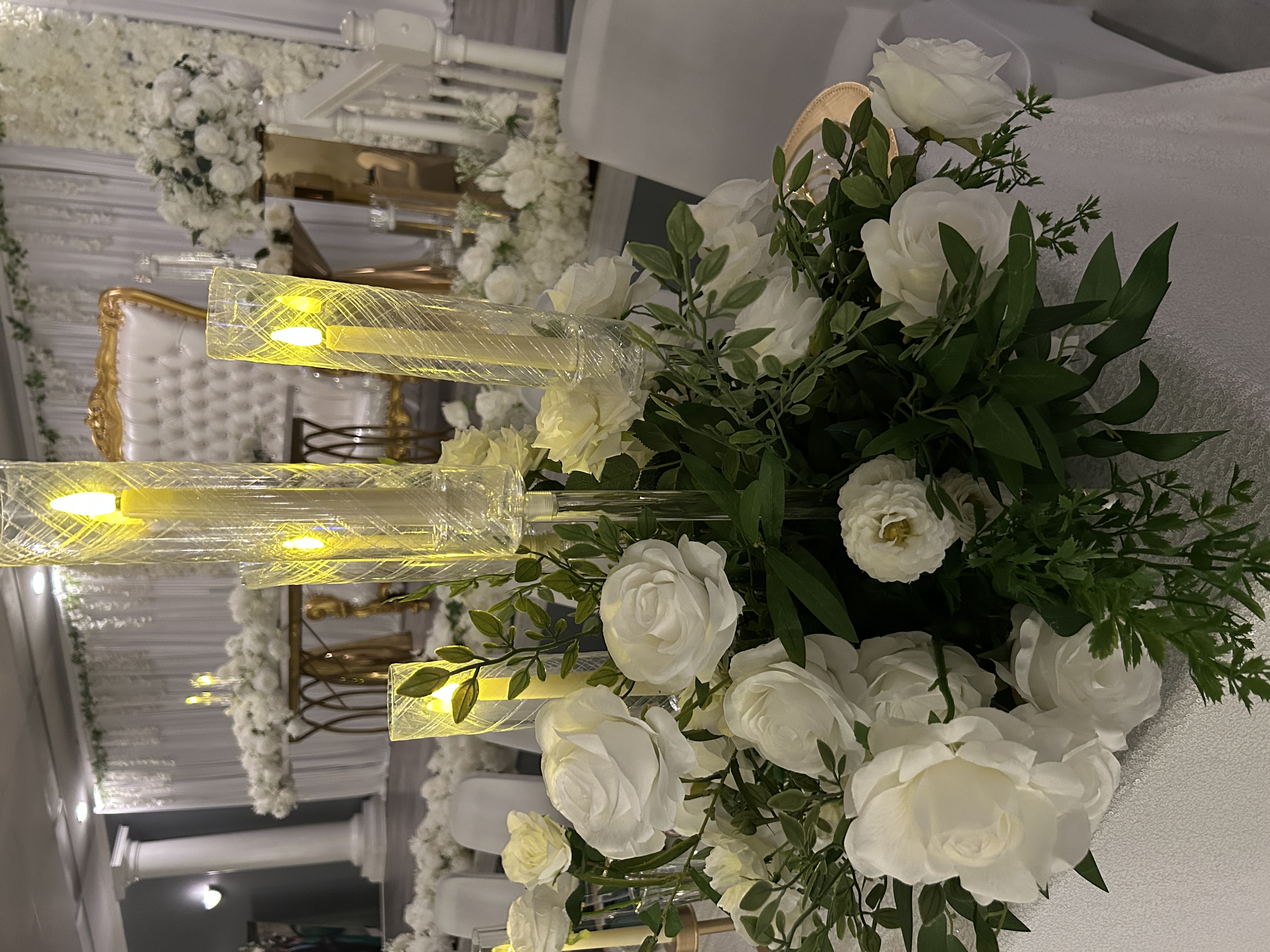 White floral reception centerpiece with candlelight and luxury seating