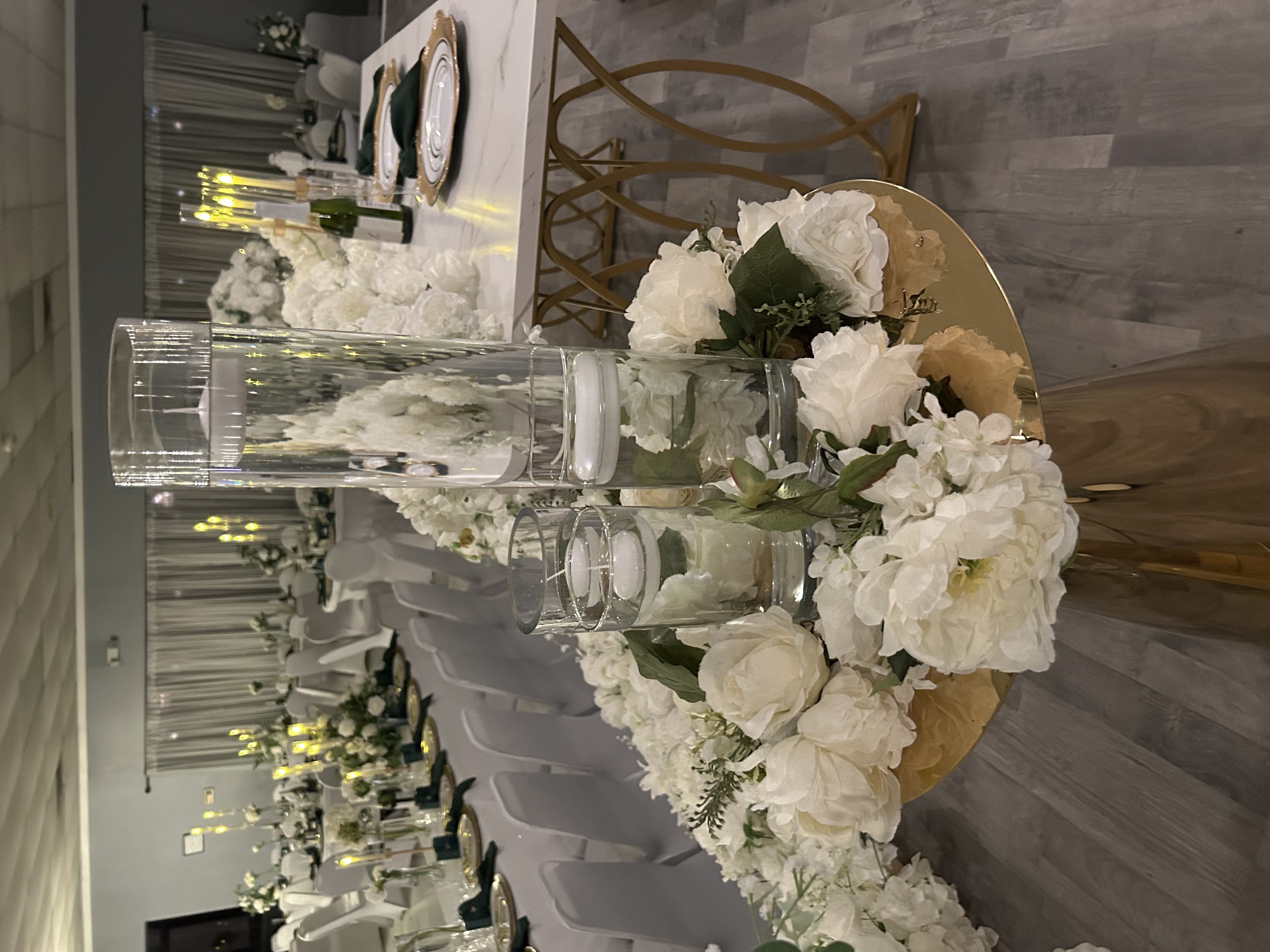 White floral aisle arrangement with glass candle holders